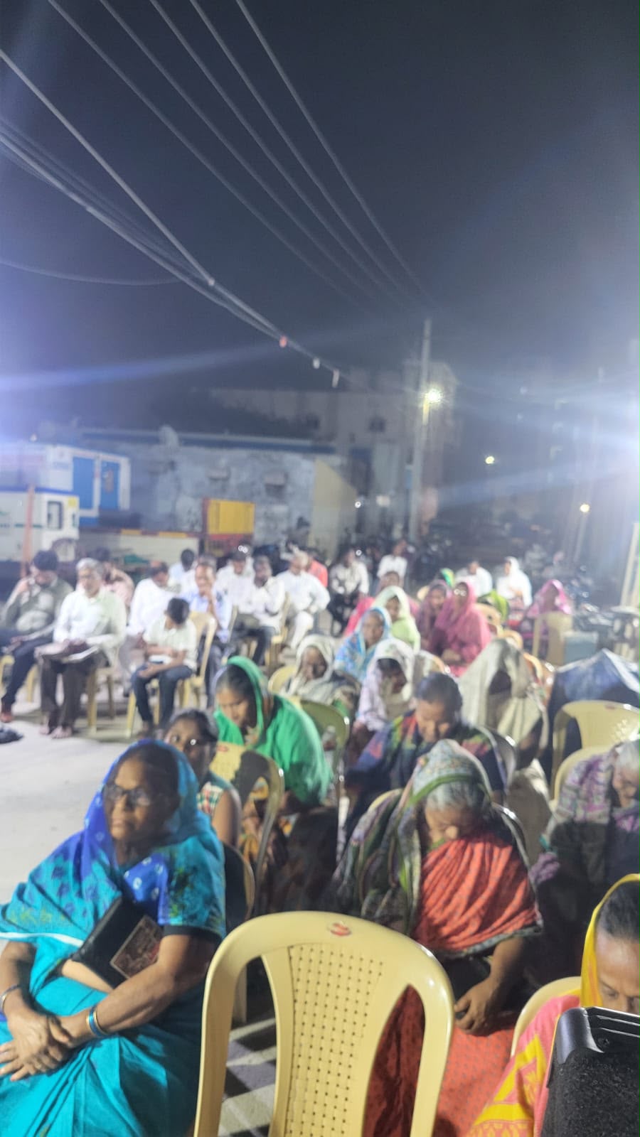 Open-air meeting Sisters seated at an evening open-air meeting