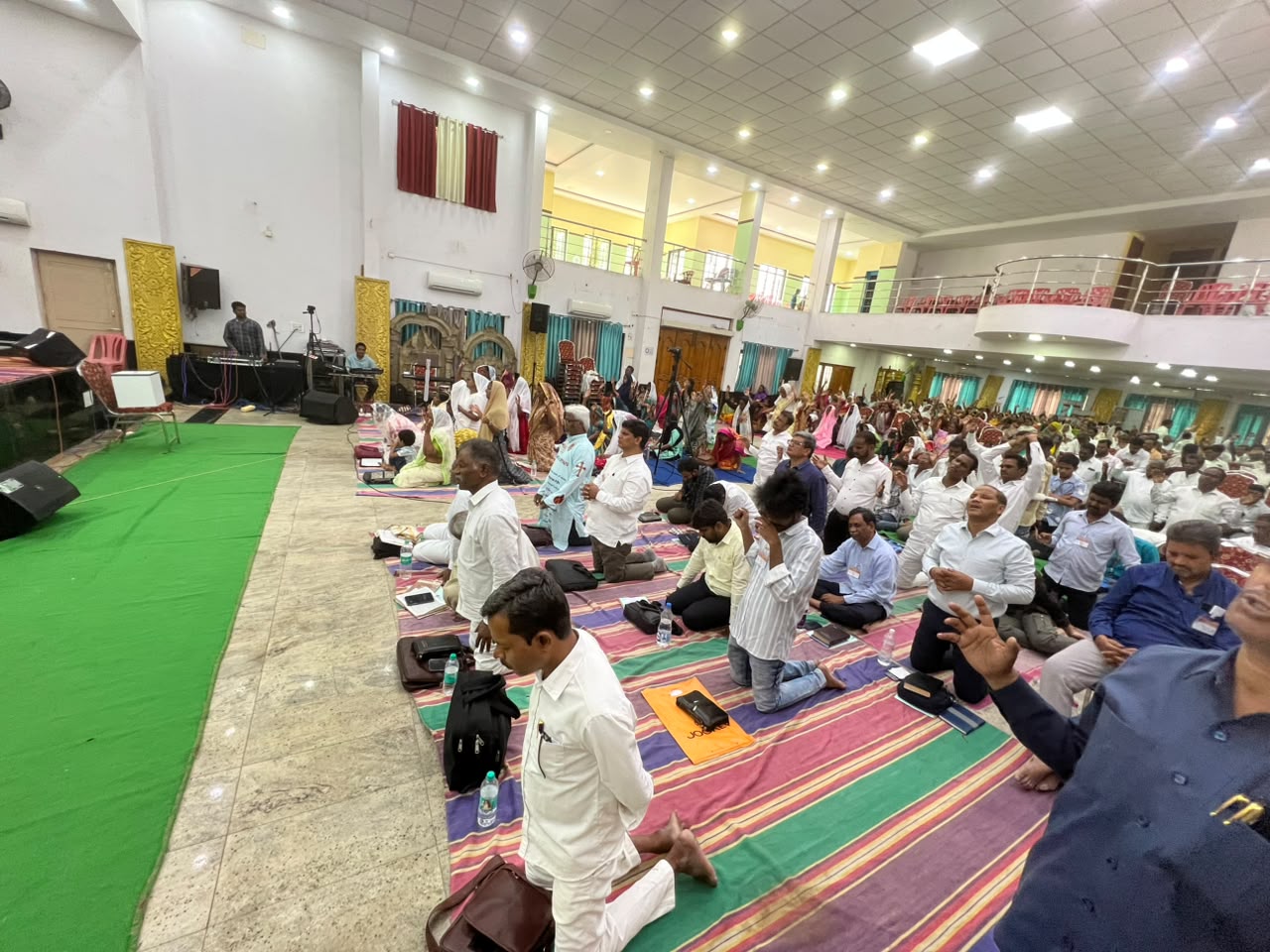 Prayer Festival 2026 Believers kneeling in prayer across the convention hall